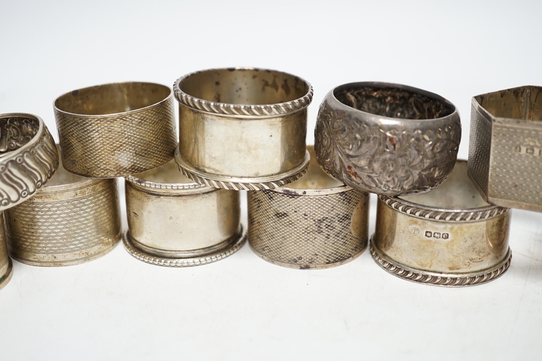 Eleven assorted early 20th century and later silver napkin rings, various dates and makers, 9.2oz. Poor to fair condition.